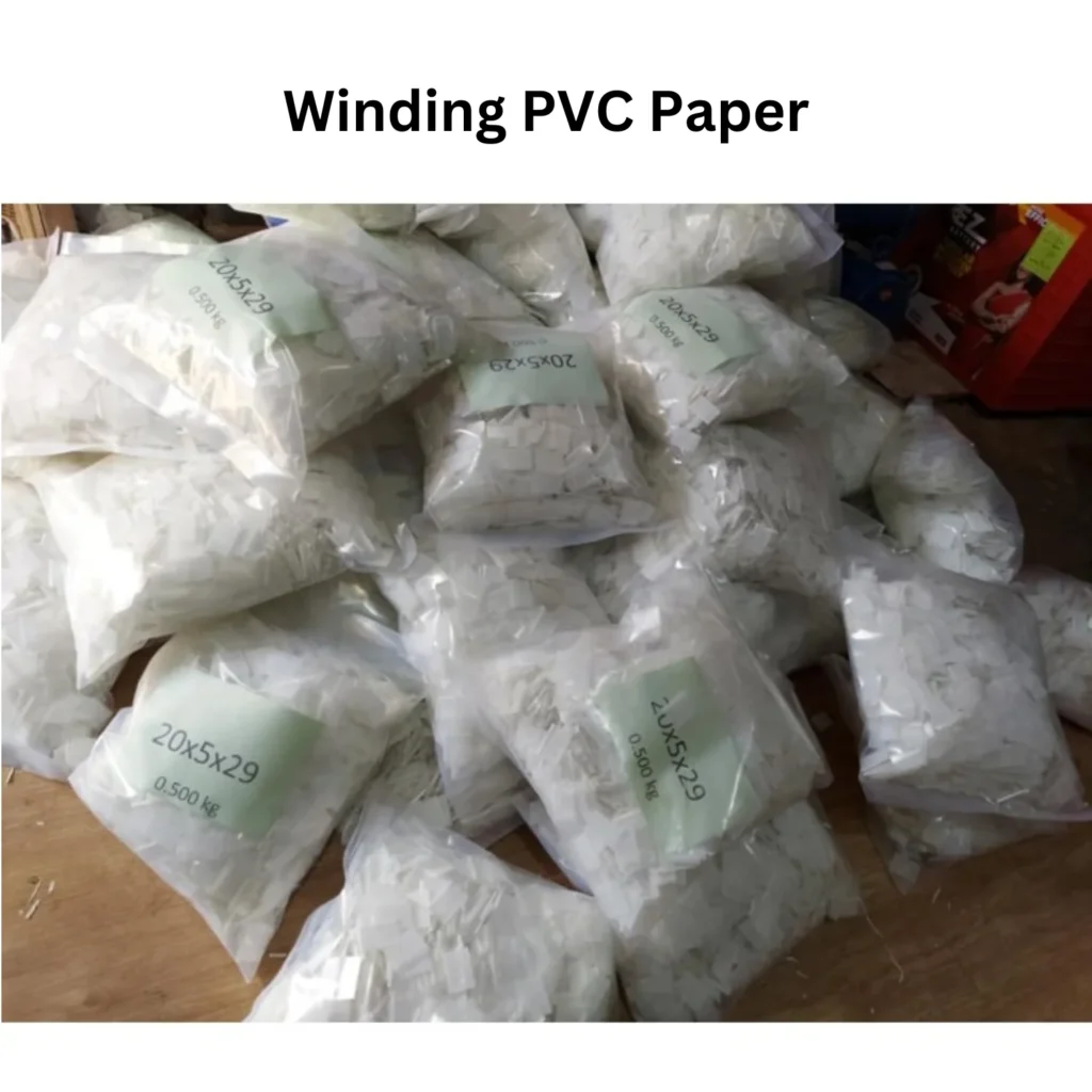 A collection of white plastic bags marked with "winding PVC paper," arranged in a disorganized pile