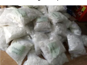 A collection of white plastic bags marked with "winding PVC paper," arranged in a disorganized pile