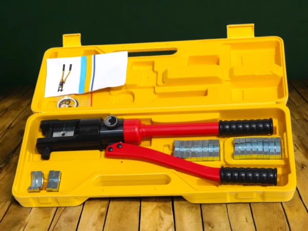 Red Hydraulic Crimping Tool in yello color box placed on wooden table